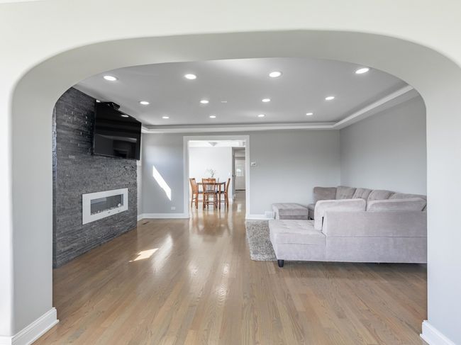 Sun-drenched living room with gleaming hardwood fl | Image 16