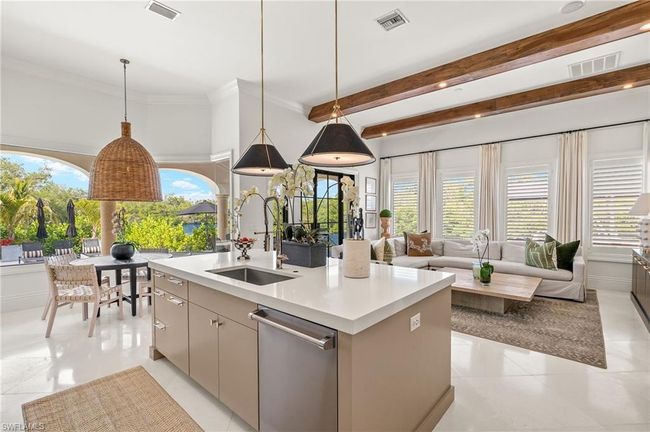 Kitchen with stainless steel dishwasher, light countertops, a sink, and visible vents | Image 13