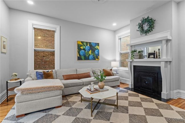 Living room with a fireplace with flush hearth, baseboards, wood finished floors, and recessed lighting | Image 7