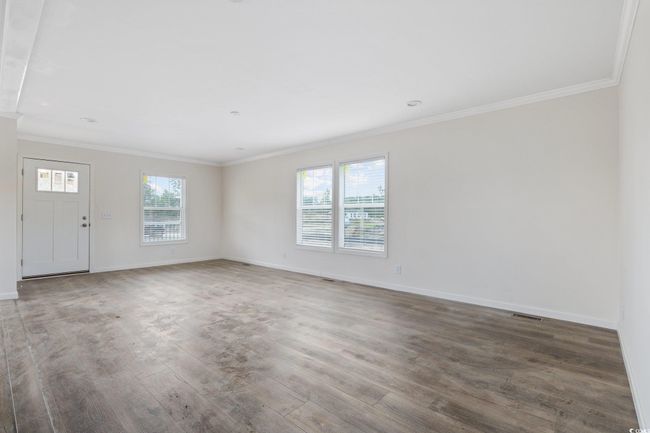 Spare room with wood finished floors and crown molding | Image 6