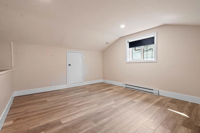Bonus room with baseboard heating, baseboards, light wood-style floors, and vaulted ceiling | Image 20