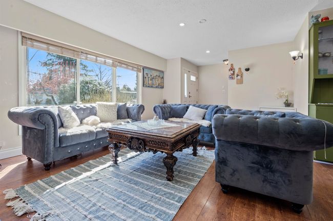 Living room with plenty of natural light, wood finished floors, and recessed lighting | Image 4