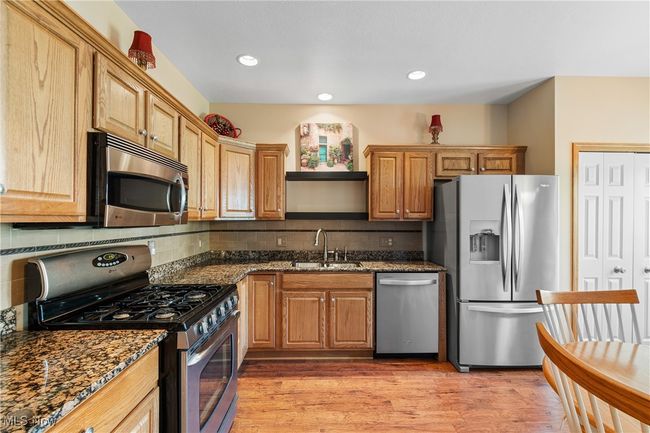 The cook of the home will enjoy this beautiful kitchen with granite counters, stainless appliances, pantry, and laminate floors. | Image 12