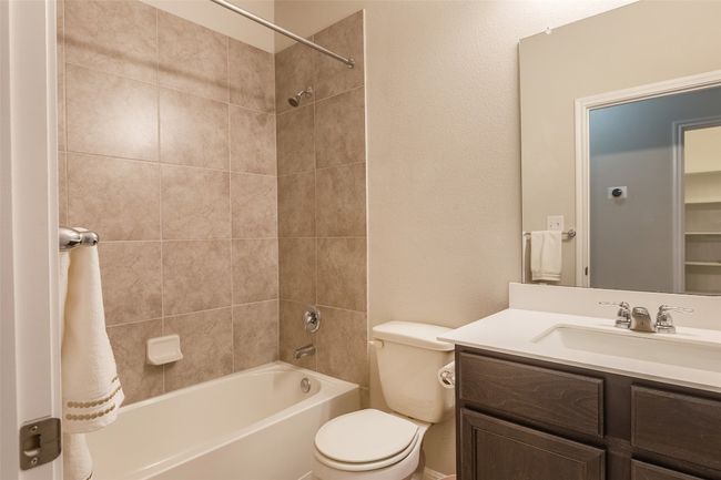 Full bathroom featuring vanity, toilet, and shower / washtub combination | Image 23
