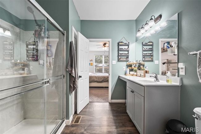Bathroom with ensuite bathroom, vanity, wood finished floors, and a stall shower | Image 17