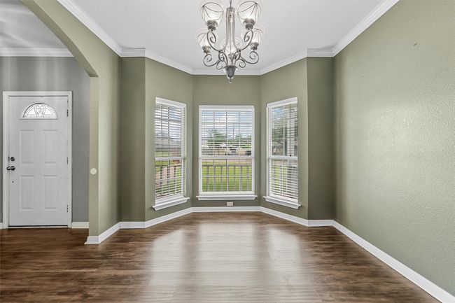 Entrance foyer featuring arched walkways, wood finished floors, a chandelier, and ornamental​​‌​​​​‌​​‌‌​‌‌​​​‌‌​​‌‌​‌​​​​​‌ molding | Image 9