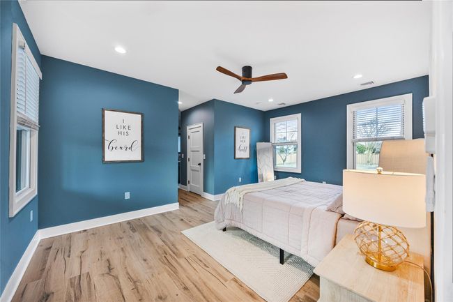 Bedroom with baseboards, visible vents, wood finished floors, and recessed lighting | Image 23