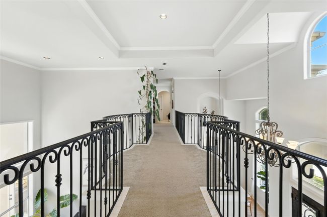 Corridor featuring an upstairs landing, light colored carpet, a chandelier, recessed lighting, and crown molding | Image 34
