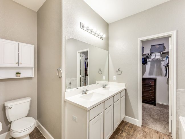 Bathroom with wood finished floors, double vanity, and a spacious closet | Image 22