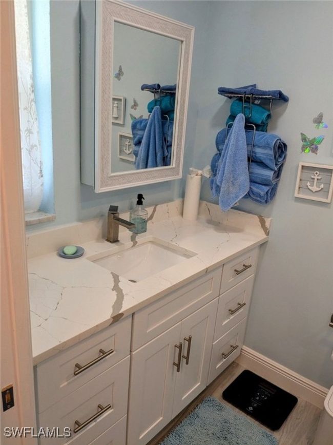 Bathroom featuring vanity, baseboards, and wood finished floors | Image 28