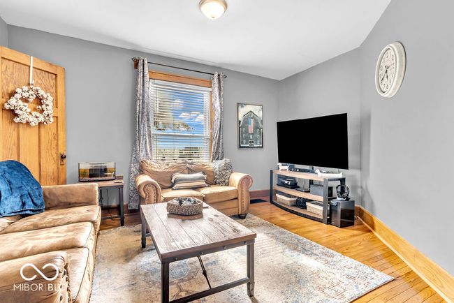 living room with wood-type flooring and baseboards | Image 16