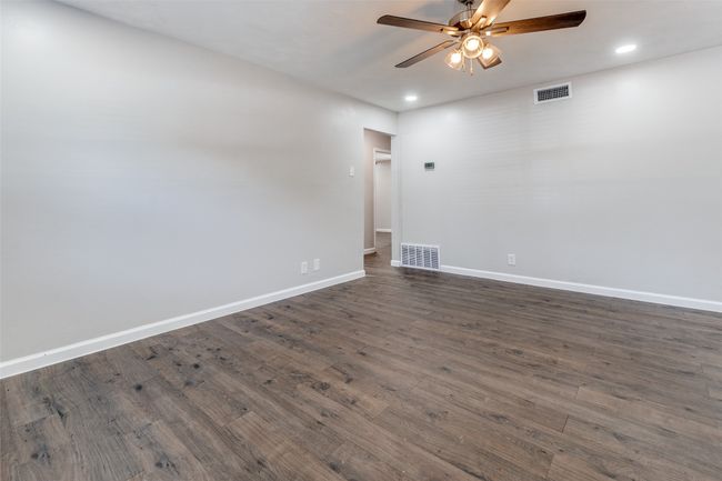 Spare room featuring a ceiling fan, recessed lighting, and dark wood finished floors | Image 8