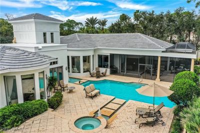 View of swimming pool with a sunroom and a patio | Image 3