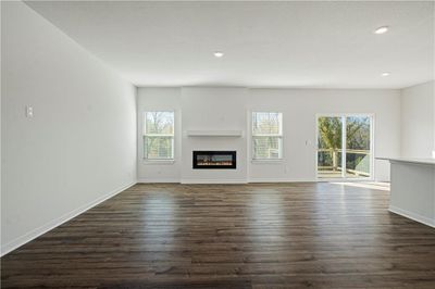 Unfurnished living room featuring dark hardwood / wood-style flooring | Image 3