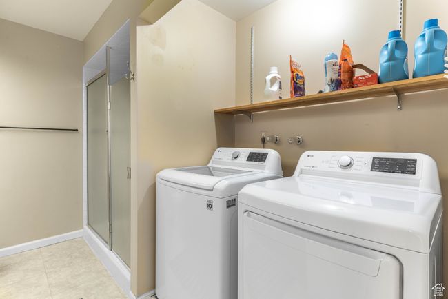 Washroom featuring baseboards, washer and clothes dryer, and laundry area | Image 25