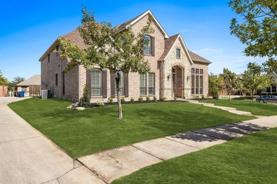 View of front facade with a front lawn and central AC unit | Image 2