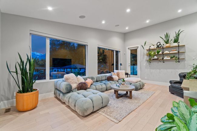Living area with wood finished floors, recessed lighting, and baseboards | Image 24