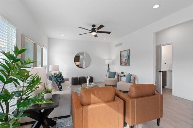 Living room with ceiling fan and light wood-type flooring | Image 6
