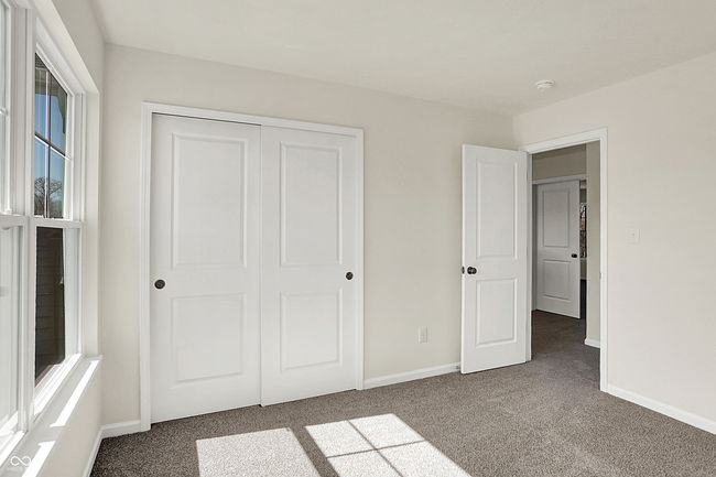 unfurnished bedroom with a closet, baseboards, and carpet flooring | Image 28