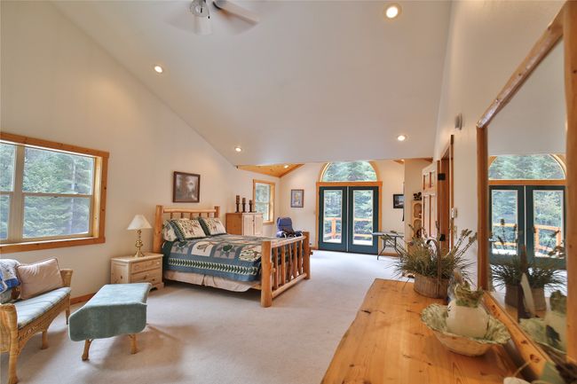 Carpeted bedroom featuring access to exterior, multiple windows, and french doors | Image 33