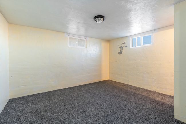 Bright lower-level room with multiple windows for natural light. | Image 55