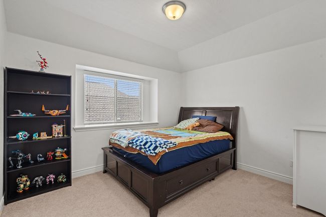 Bedroom featuring light carpet, baseboards, and vaulted ceiling | Image 19
