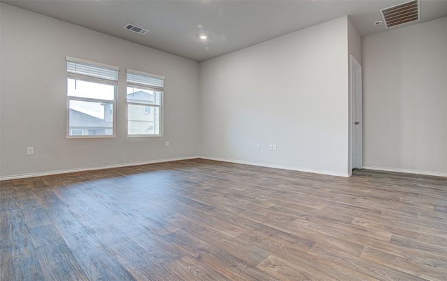 Empty room featuring visible vents, baseboards, and wood finished floors | Image 9