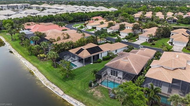 Aerial view of residential area featuring a nearby body of water and a pool area | Image 38
