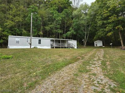 View of yard with a storage unit | Image 2