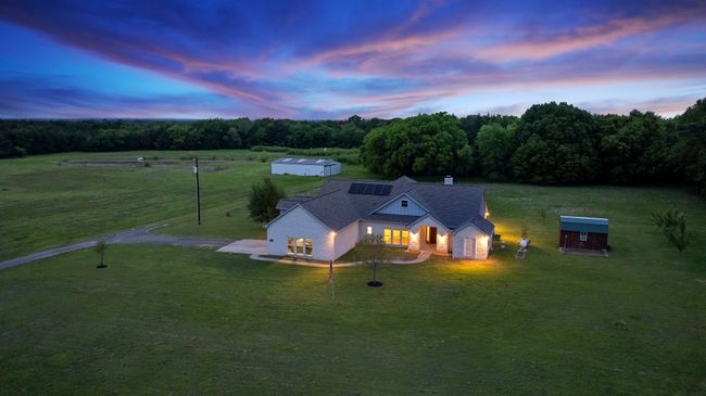 Aerial view at dusk featuring a wooded view | Image 20
