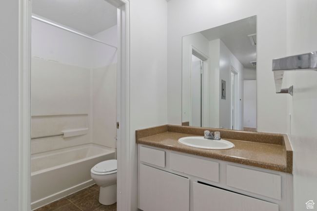 Full bathroom with vanity, washtub / shower combination, and tile patterned flooring | Image 14
