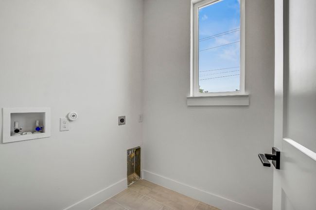 Laundry room featuring hookup for an electric dryer, hookup for a washing machine, baseboards, hookup for a gas dryer, and light tile patterned floors | Image 22