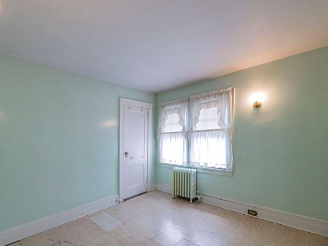 Spare room with radiator and tile patterned floors | Image 29