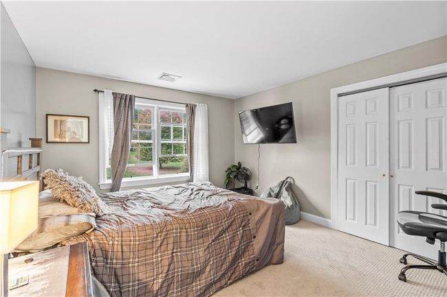 Bedroom with light colored carpet, a closet, and baseboards | Image 25
