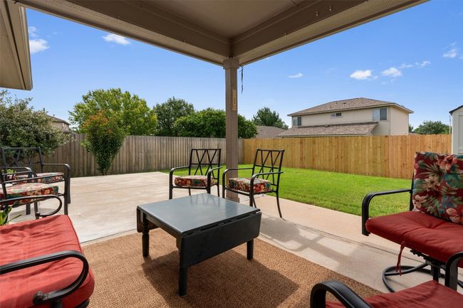 Fenced backyard featuring a extra large patio area | Image 26