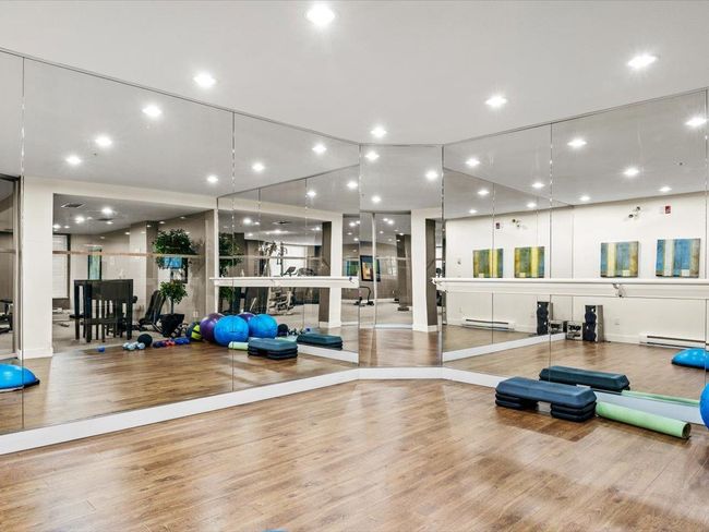 Workout area featuring wood finished floors, baseboard heating, and recessed lighting | Image 18