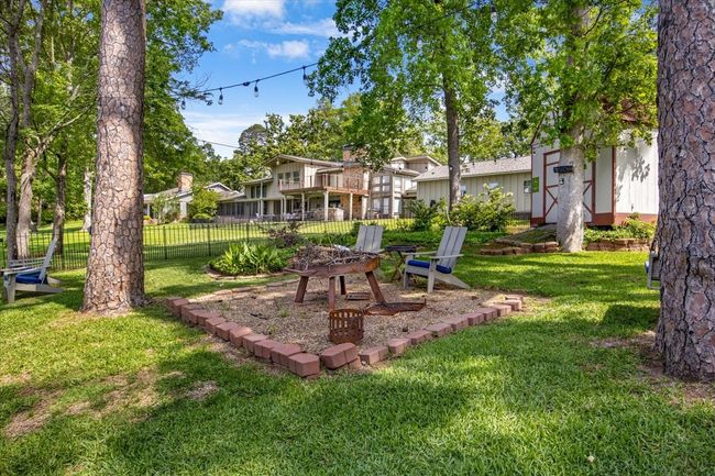 View of yard featuring an outdoor fire pit and fence | Image 30