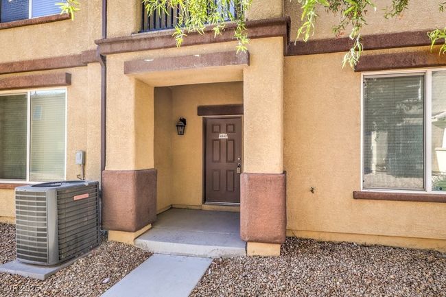 Entrance to property featuring stucco siding and central AC unit | Image 10