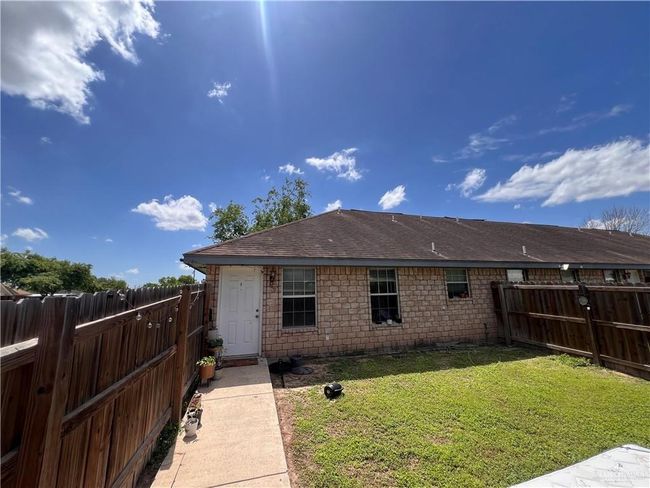 Back of house featuring a lawn, a fenced backyard, and roof with shingles | Image 9