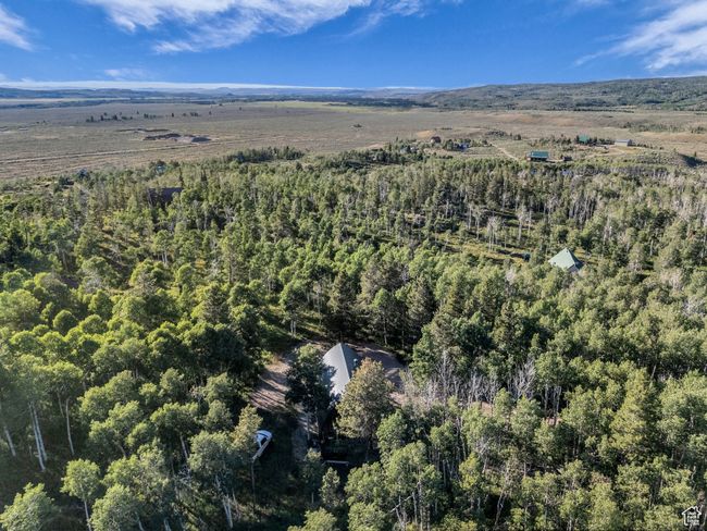 Aerial view of property's location featuring a heavily wooded area | Image 26