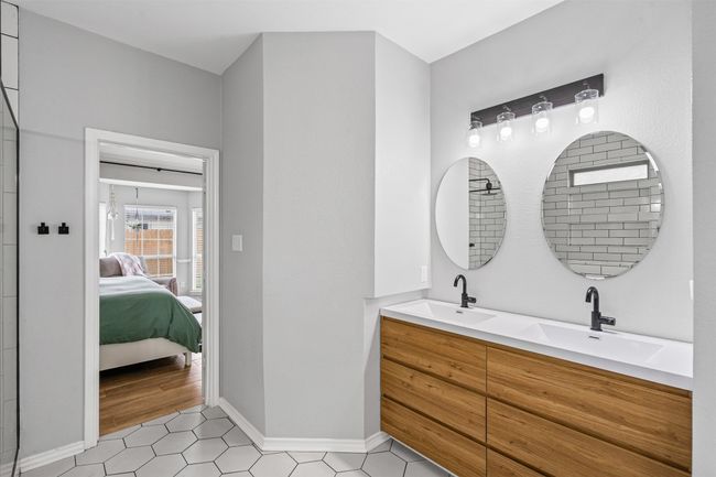 Ensuite bathroom with double vanity and tile patterned flooring | Image 23