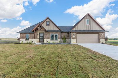 Craftsman inspired home with a garage and a front yard | Image 1