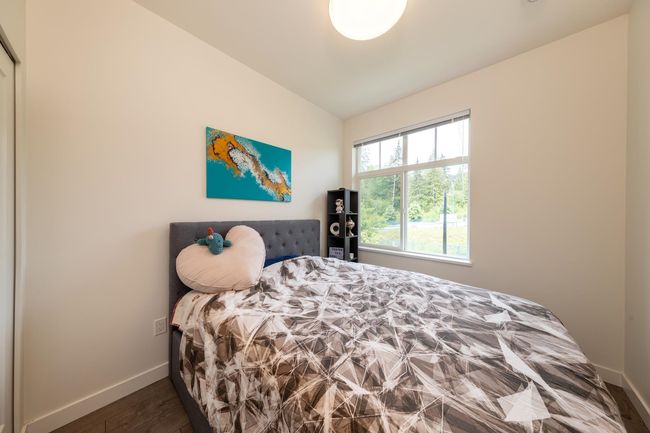Bedroom with baseboards, vaulted ceiling, and wood finished floors | Image 18