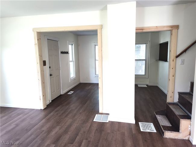 Entryway featuring stairs, dark wood-type flooring, healthy amount of natural light, and baseboards | Image 16