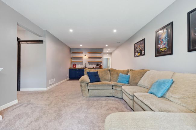 Another view into the freshly painted family room which features a wet bar. | Image 16