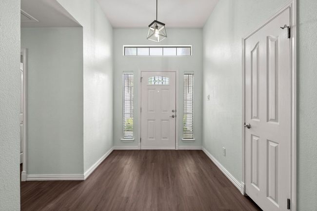 Foyer entrance with dark wood finished floors and baseboards | Image 4