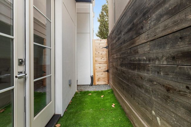 French doors open from the downstairs bedroom to a private grassy yard—perfect for pets. | Image 42