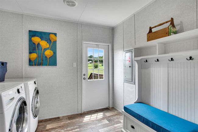 Laundry room that leads to backyard. Washer and dryer convey! | Image 25