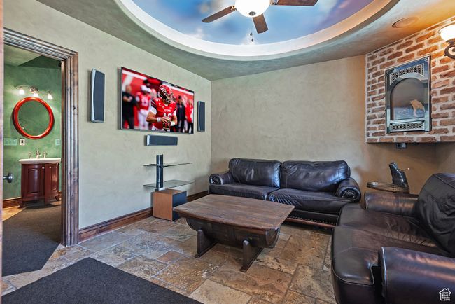 Living area with stone tile floors, baseboards, and a ceiling fan | Image 38