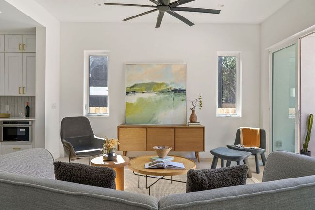 Living room with ceiling fan | Image 7
